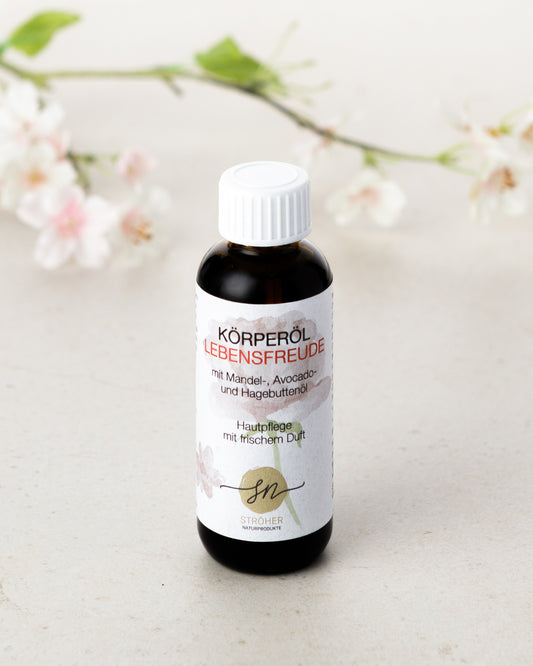 Natürliches Körperöl Lebensfreude Hautpflege mit frischem, blumigen Duft in wiederverwendbarem Glasgefäß mit Deko