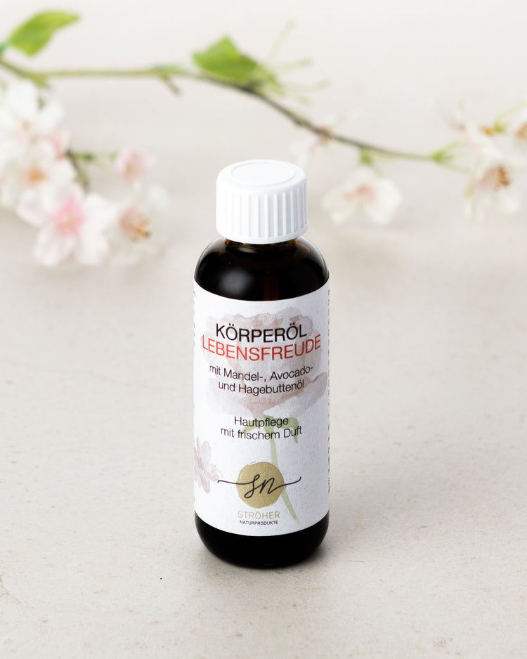 Natürliches Körperöl Lebensfreude Hautpflege mit frischem, blumigen Duft in wiederverwendbarem Glasgefäß mit Deko